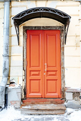 Old Moscow street. Red old wooden door. Vertical photo. City old architecture