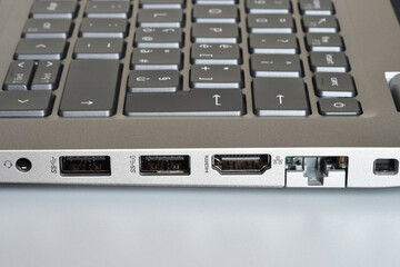 Detail of headphone jacks, usb ports, hdmi and rj45 lan port on the side of a modern laptop