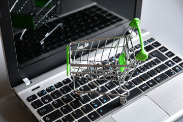 Shopping online. Shopping cart on a laptop keyboard. Concept for online shopping.