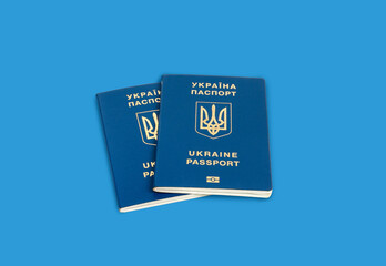 two Ukrainian passports on a blue background