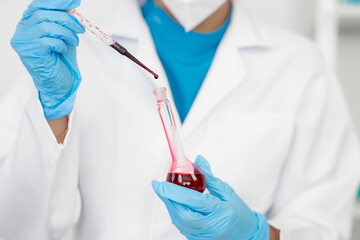 Female doctor working with blood sample in laboratory