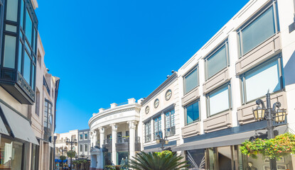 Luxury street in Beverly Hills under a blue sky