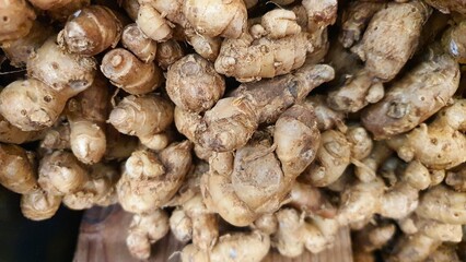 Close up pile of tasty fresh ginger sold at the market as a background.