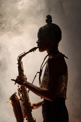 Side view outline of Black woman playing saxophone and performing jazz music with smoke