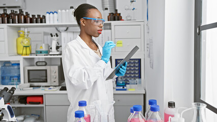 Passionate african american female scientist in lab gloves, fascinated by the power of medical...