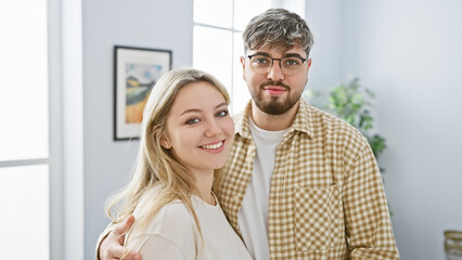 A loving couple embraces in a bright modern living room, exuding happiness and comfort.