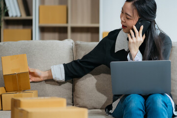 young asian women using smartphone contacted a customer asking for a shipping address