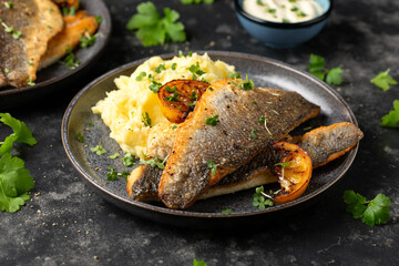 Pan fried sea bass fillets served with mashed potatoes and caramelised lemon - obrazy, fototapety, plakaty