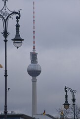 Berlin, Germany - Jan 14, 2024: People walking in Berlin on sunday. Streets and buildings. Lifestyle in the urban area. Cloudy winter day. Selective focus