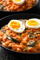 Chickpea, spinach, tomato and egg curry. Healthy food.