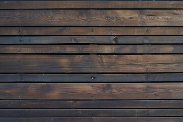 Obraz premium A wall of wooden slats in the color of dark wood with a pattern of wall panels in the texture background