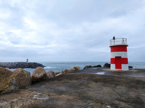 Red and White Lighthouse on Top of Pier