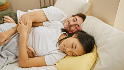 An intimate couple, a man and a woman, peacefully asleep in a cozy, well-lit bedroom, embodying love and comfort.