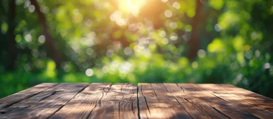 Zelfklevend Fotobehang Wooden table with blurry summer nature bokeh background. Generated AI image © Leafart