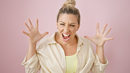 Young blonde woman screaming loudly over isolated pink background