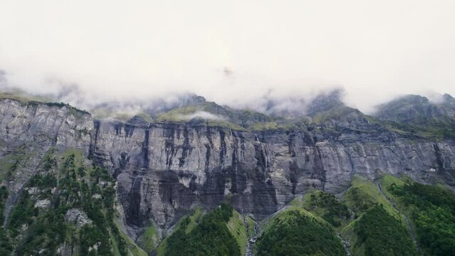 Giffre valley of mountain range with cascade and foggy in French Alps borderland at France