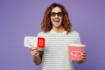 Young man he wears grey striped t-shirt casual clothes 3d glasses watch movie film hold ticket...