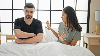 Beautiful couple arguing in bedroom, a serious disagreement amidst a lovely morning, stressed...