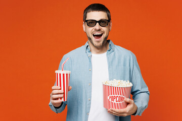 Young happy man he wears blue shirt white t-shirt casual clothes 3d glasses watch movie film hold...