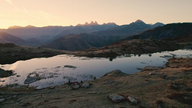 Sunrise shines over Lac Guichard with Arves massif and lake reflection in autumn at Aiguilles d'Arves, French Alps, France