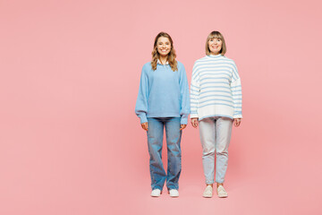 Full body smiling happy cheerful elder parent mom with young adult daughter two women together wear blue casual clothes look camera isolated on plain pastel light pink background. Family day concept. - obrazy, fototapety, plakaty