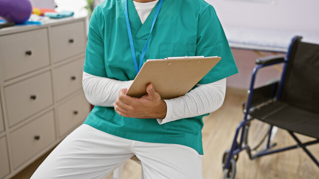 Hispanic man therapist's hands diligently jotting down patient's recovery notes at homely rehab clinic - Powered by Adobe