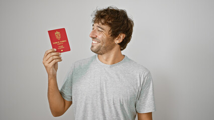 Jovial young man proudly flaunting his norwegian passport, basking in pure joy and confidence, isolated on a white background - obrazy, fototapety, plakaty