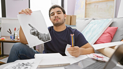 Fototapeta premium Bearded man displaying a hand drawing in a creative indoor studio environment, imbuing a sense of artistic education.