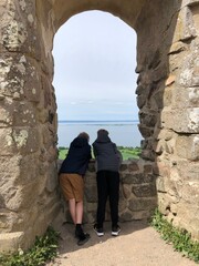 couple looking at the sea in the window in the old ruin