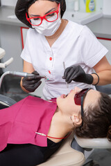Young Female patient with pretty smile examining dental inspection at dentist clinic. Healthy teeth and medicine, stomatology concept