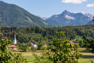 Remote village with scenic view of untamed mountain peaks of Karawanks seen from Feistritz im...