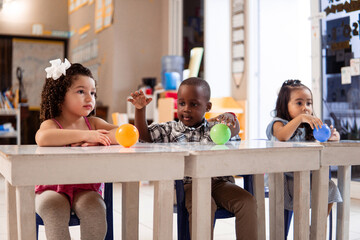 Three preschool children in a class of kindergarten.