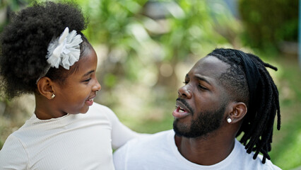 African american father and daughter smiling confident hugging each other at park