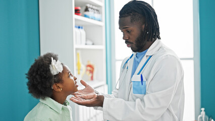 Doctor and patient having medical consultation examining throat at the clinic