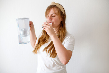 woman drinks purified water from a filter
