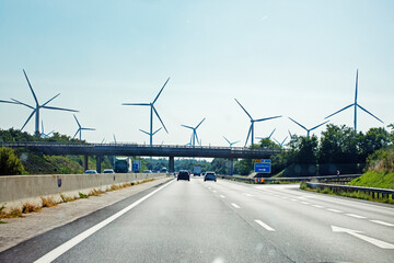 wind power station along the highway during the day. Crisis and Energy Saving