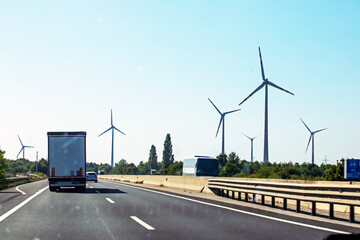 wind farm along the highway during the day. Crisis Saving electricity