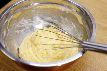 dough with a whisk in a deep bowl