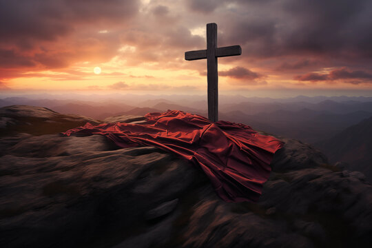 A christian cross with a red cloth, on top of the mountain against sunset light and cloudy sky in a dramatic scenery. Fosus on the crooss