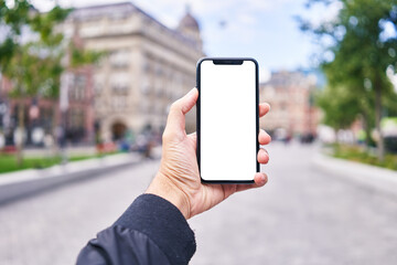 Man holding smartphone showing white blank screen at amsterdam