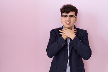 Young non binary man with beard wearing suit and tie shouting and suffocate because painful strangle. health problem. asphyxiate and suicide concept.