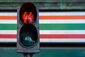 Red traffic light with replaced the figure with two same-sex girl. LGBT, LGBTQ friendly city. Space