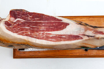 Piece of black leg Iberian ham on cutting board, 