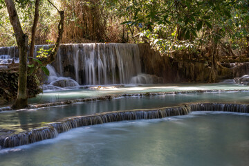 The Kuang Si Waterfall is located 30 km to the south of Luang Prabang in the Southeast Asian country of Laos.