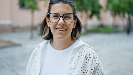Beautiful young hispanic woman smiling confident in the streets of Stockholm