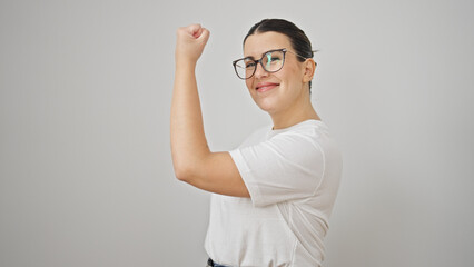 Young beautiful hispanic woman smiling confident doing strong gesture with arms over isolated white...
