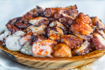 Galician-style octopus dish, served on its typical wooden plate