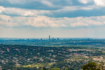 Elevated Panoramic view of Johannesburg - Northern View with  Sandton centre of horizon from Northcliff with white soft clouds and clou