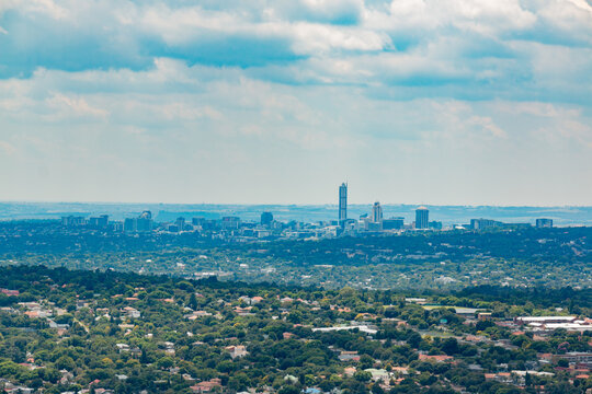 Hazy elevated Panoramic view of Johannesburg - Northern View toward Sandton from Northcliff with white soft clouds - closer