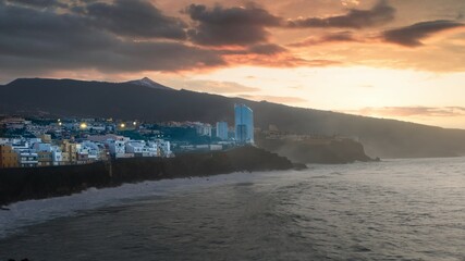 A sunset on the beach of puerto de la cruz de tenerife